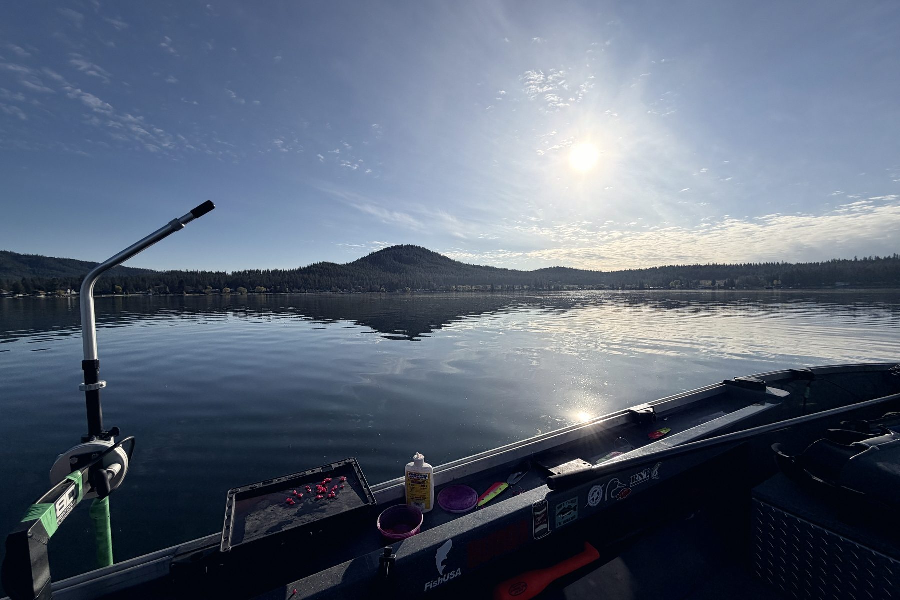 A boat console with tackle laid out and electronics running, ready to fish.